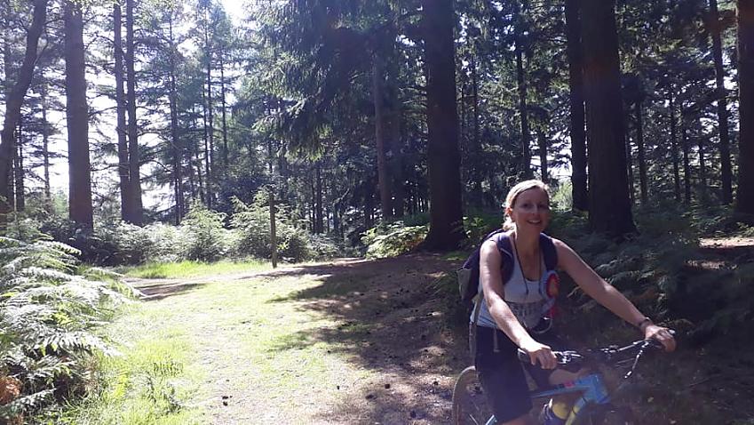 Laura riding through the woods above Holmwood