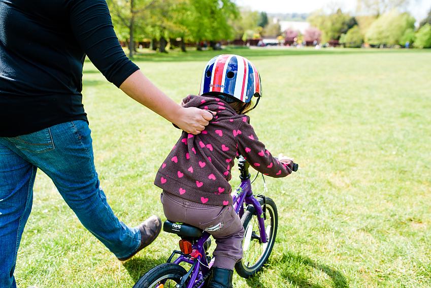 Lightly holding the back of a child’s jumper can help them to learn to cycle 