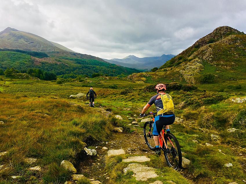 Two mountain bikers in Welsh mountain landscape