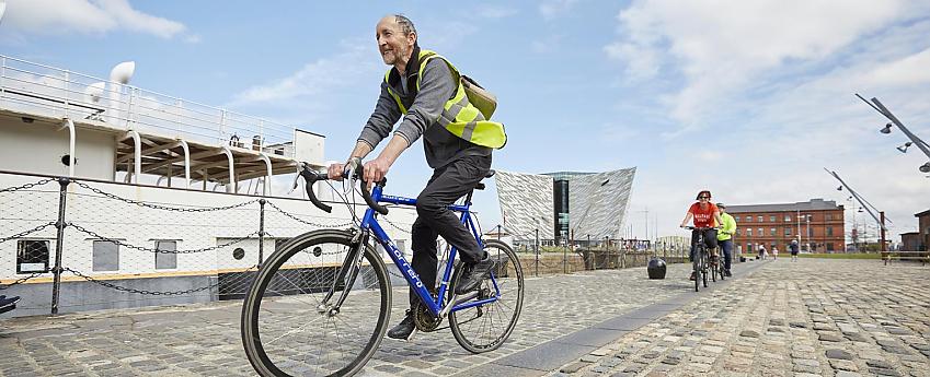 Cyclist in high-viz on the Belfast dock-side