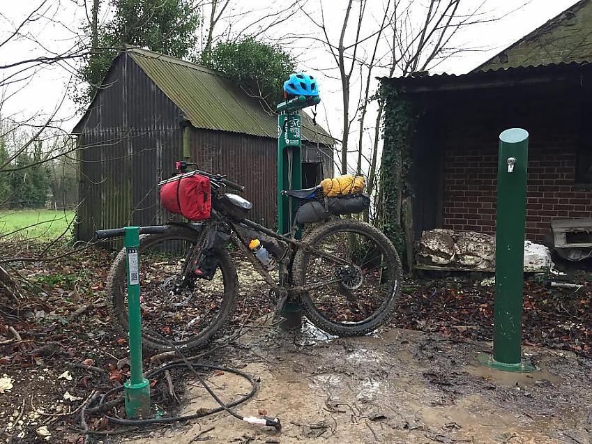 A very muddy mountain bike at the tool station on the South Downs Way