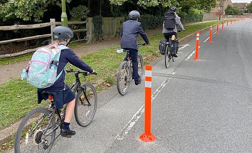 Children cycling to school along a temporary cycle lane