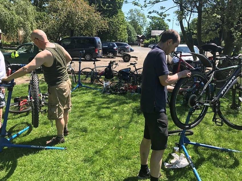 Fixing bikes in the sunshine at a Bike Big Revival event