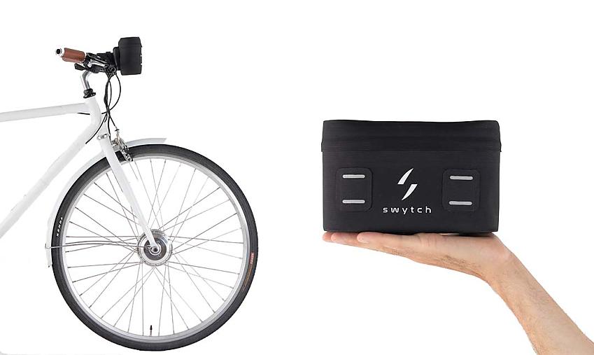 A montage to show how compact the power pack is. On the left, is the front of bike, a white flatbar hybrid, with the pack fixed to the bar. On the right, a person's hand is held flat with the pack on it