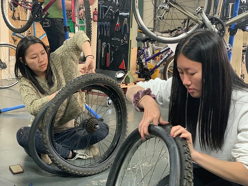 Sisters Yazmin and Joni learning how to repair inner tubes for cycling independence