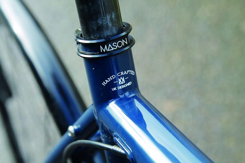 A close-up of the Mason Resolution where the top tube meets the down tube, showing the Mason logo and the words hand crafted, UK design
