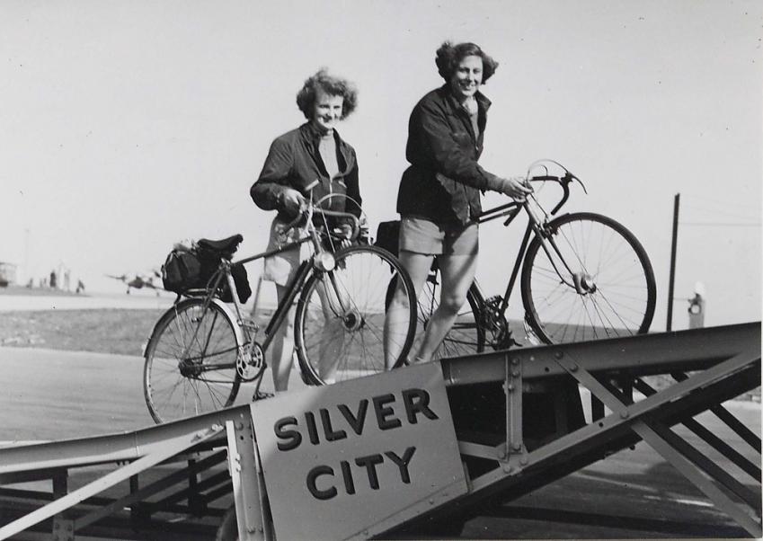 Female cyclists boarding Silver City plane with bikes