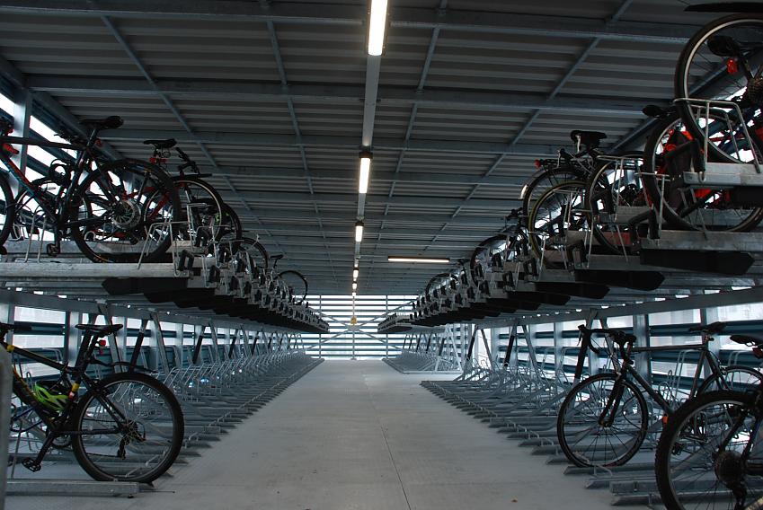 A cycle parking facility with several bikes in the parking slots