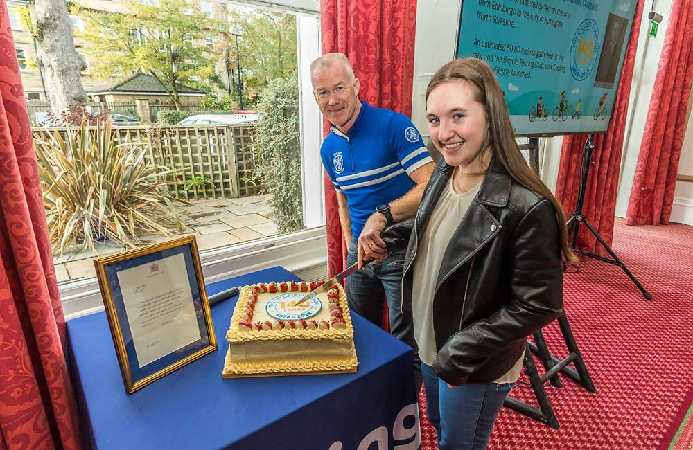 Paul Tuohy and Tourist competition junior winner Sophia Morris cut the birthday cake